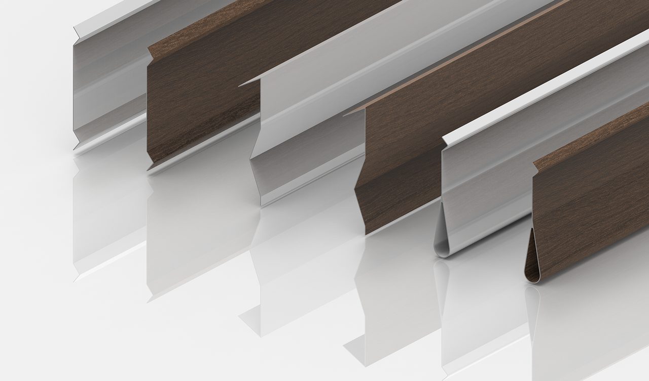 Five metal strips with angled, grooved profiles, some appearing silver and others brown with a wood-like texture, are arranged diagonally on a glossy white surface, casting soft reflections.
