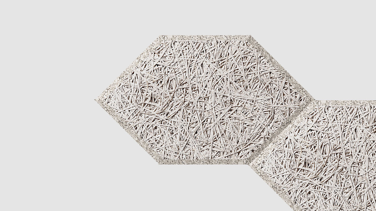 Two light gray hexagonal panels with a textured, fibrous surface pattern overlap slightly on a plain white background.