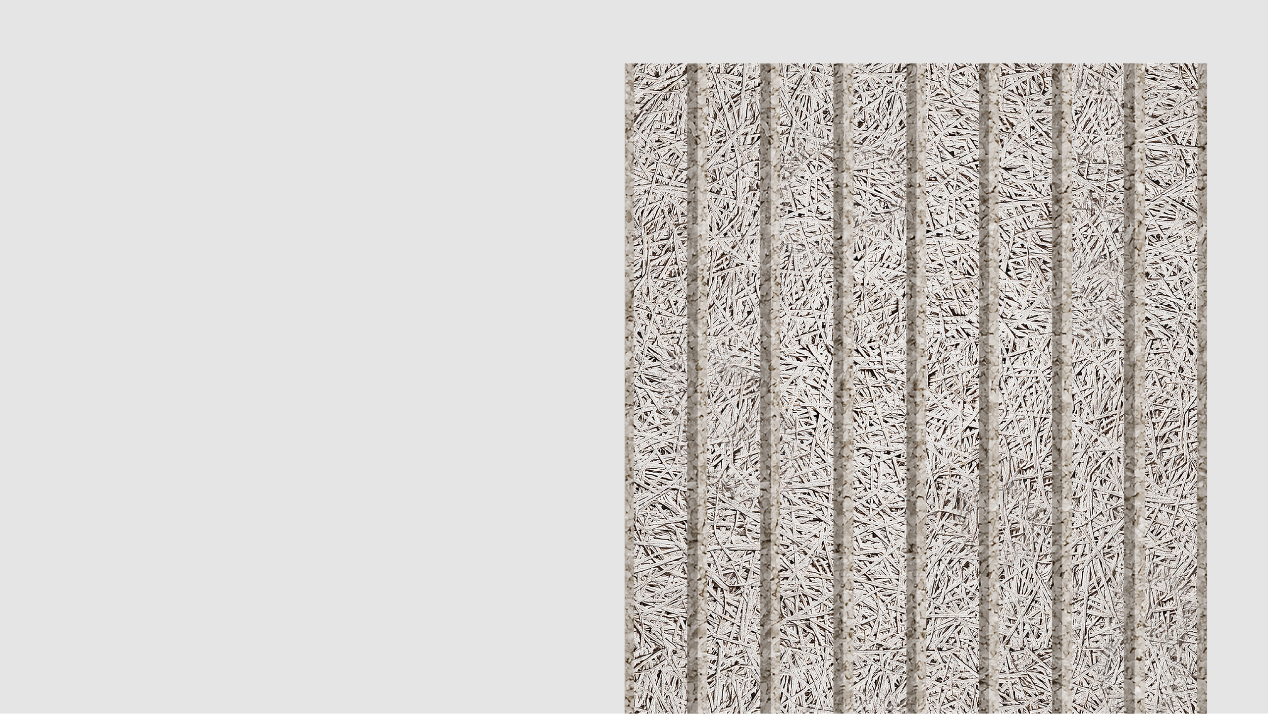 A rectangular panel made of compressed straw or wood fibers with vertical grooves, placed against a plain light gray background. The texture appears rough and fibrous.