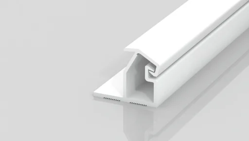 A white, T-shaped plastic or metal channel strip with a hollow section and grooves, shown on a reflective light gray surface.