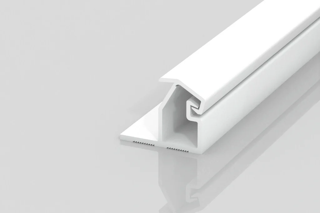 A white, T-shaped plastic or metal channel strip with a hollow section and grooves, shown on a reflective light gray surface.