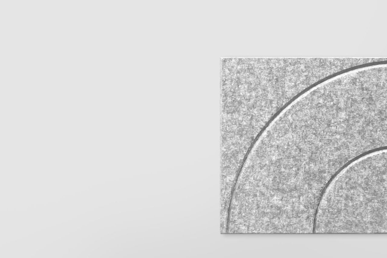 A square gray felt panel with curved embossed lines is positioned in the lower right corner against a plain light gray background.