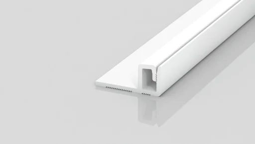 A white, L-shaped plastic trim piece with a narrow channel, displayed on a plain light gray background, shown at an angle to highlight its profile and reflective surface.