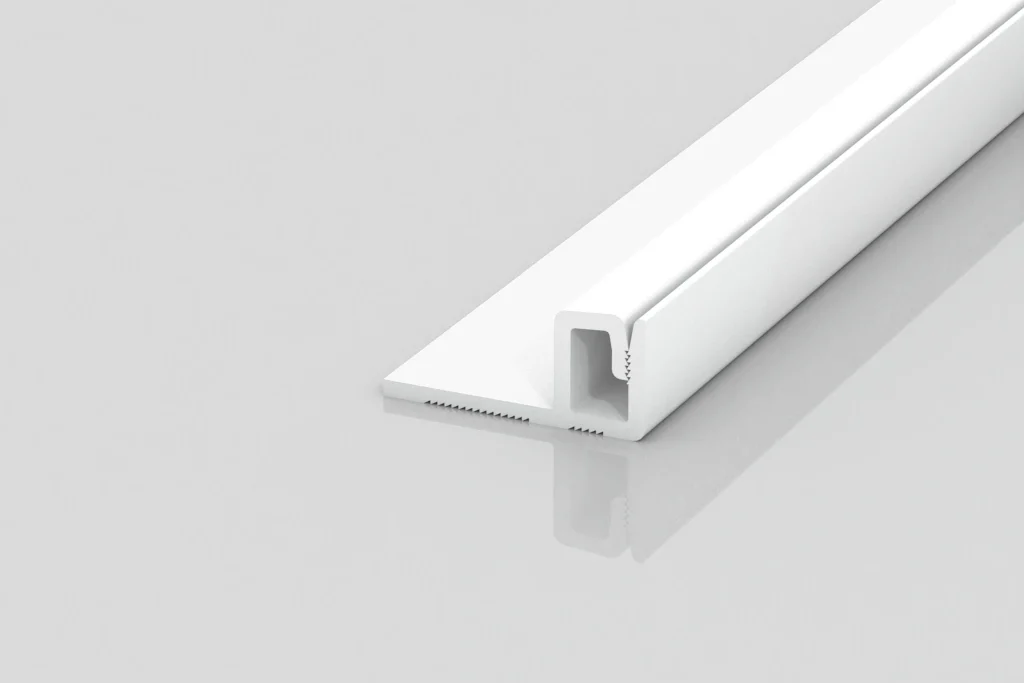 A white, L-shaped plastic trim piece with a narrow channel, displayed on a plain light gray background, shown at an angle to highlight its profile and reflective surface.