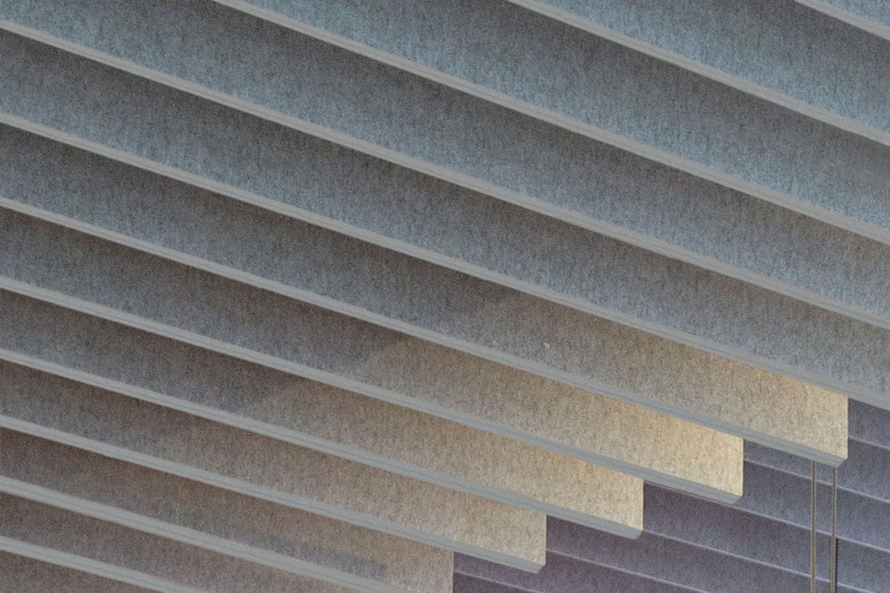 Close-up view of overlapping, horizontal concrete or stone slabs forming a modern architectural pattern with soft, diffused lighting and subtle color gradients.