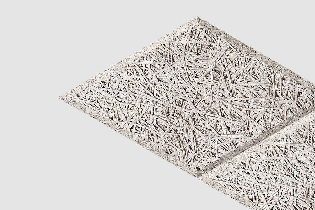 Two square ceiling tiles with a rough, interwoven wood fiber texture are positioned diagonally on a plain white background.