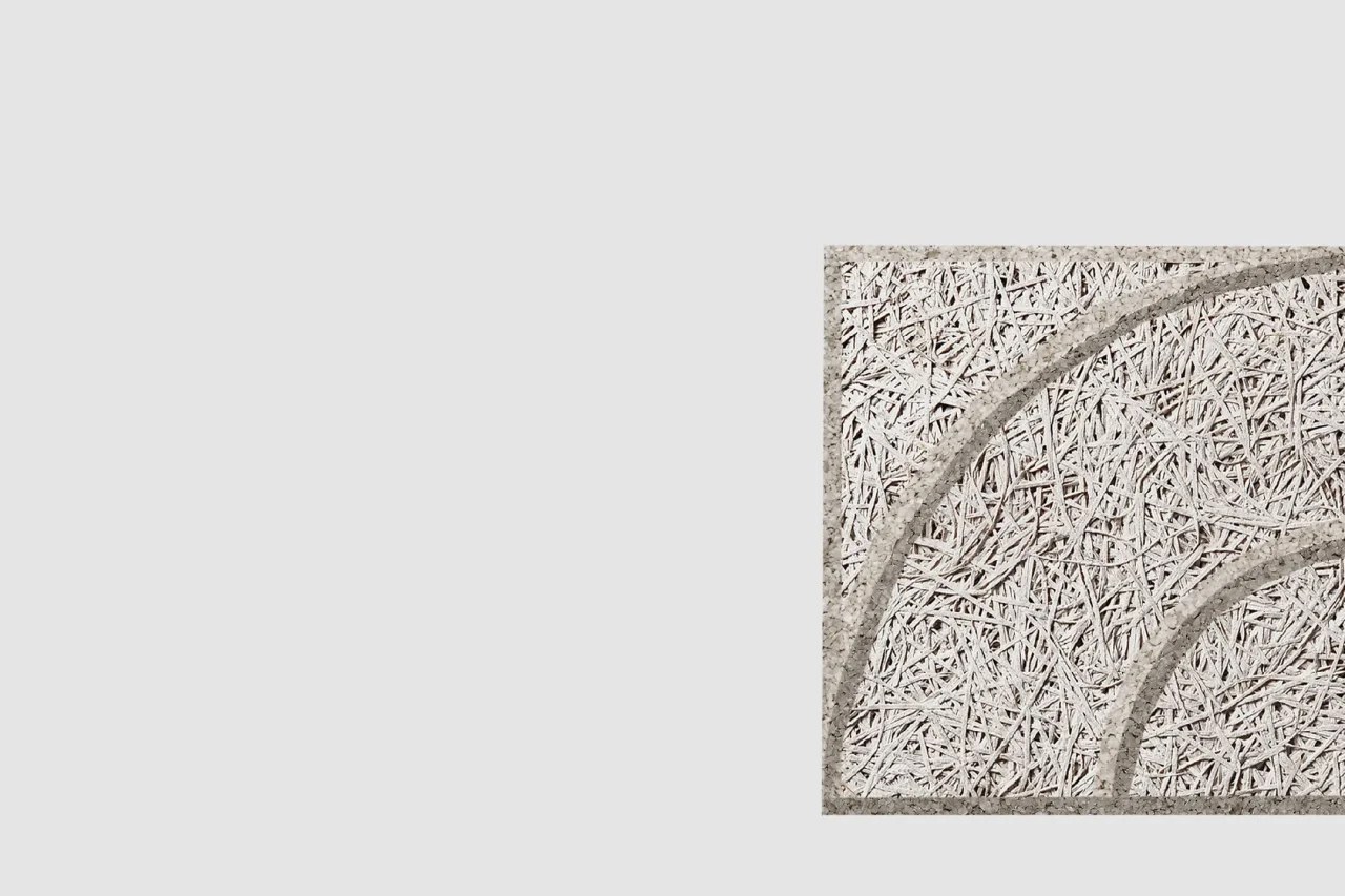 A square panel with a textured, woven straw-like surface and two curved raised lines, positioned on a plain light gray background with ample empty space on the left.